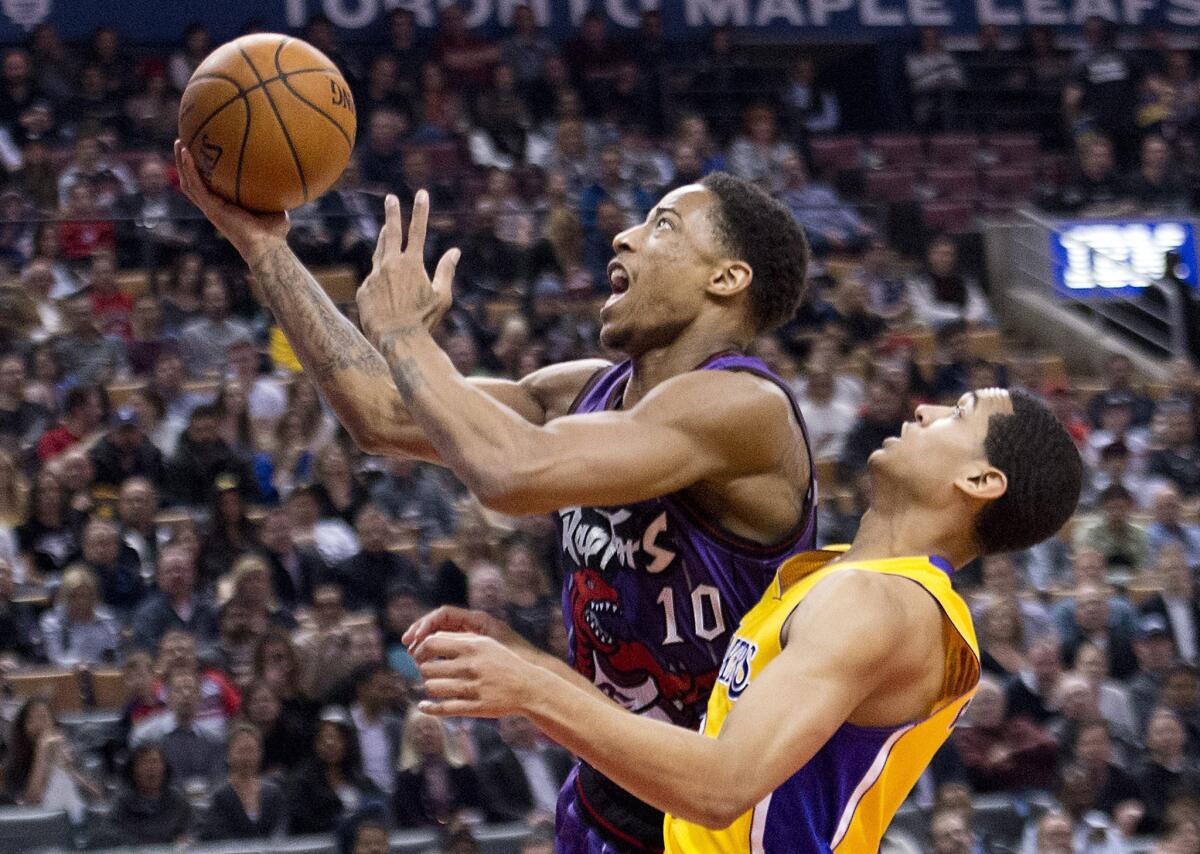 Raptors guard DeMar DeRozan drives for a layup against Lakers guard Jordan Clarkson last week. He scored a career-high 42 points against the Rockets on Monday.