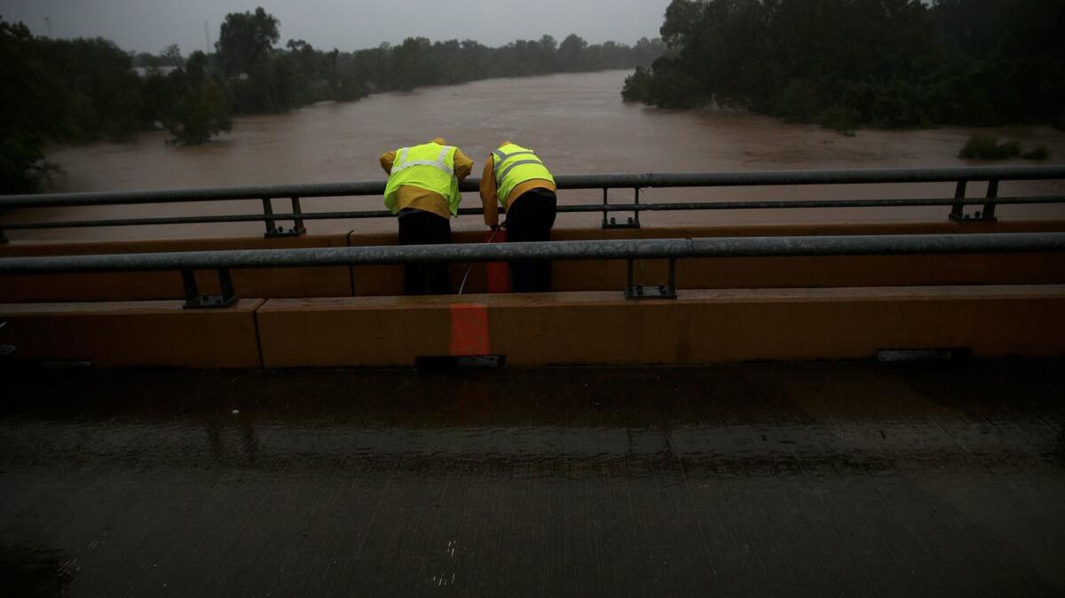 Work crews take measurements of the Brazos River as flooding continues throughout the greater Houston area.