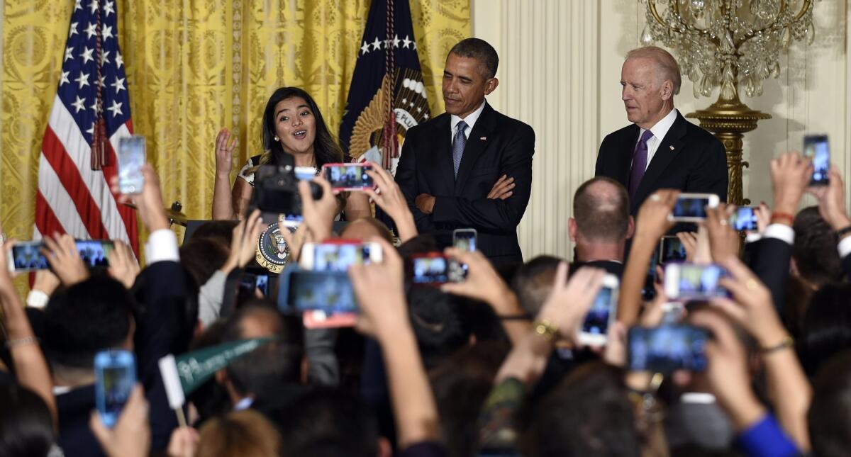 President Obama and Vice President Biden listen as Diana Calderon, a student who has benefited from the Deferred Action for Childhood Arrivals (DACA) program, speaks at a reception in the White House on Oct. 15.