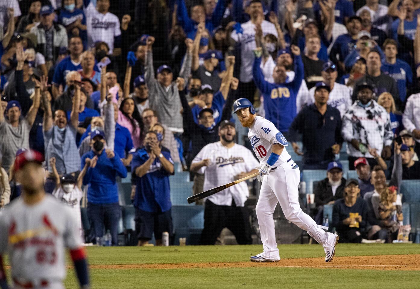 Fans react as Los Angeles Dodgers third baseman Justin Turner watches his solo homer clear the left field wall