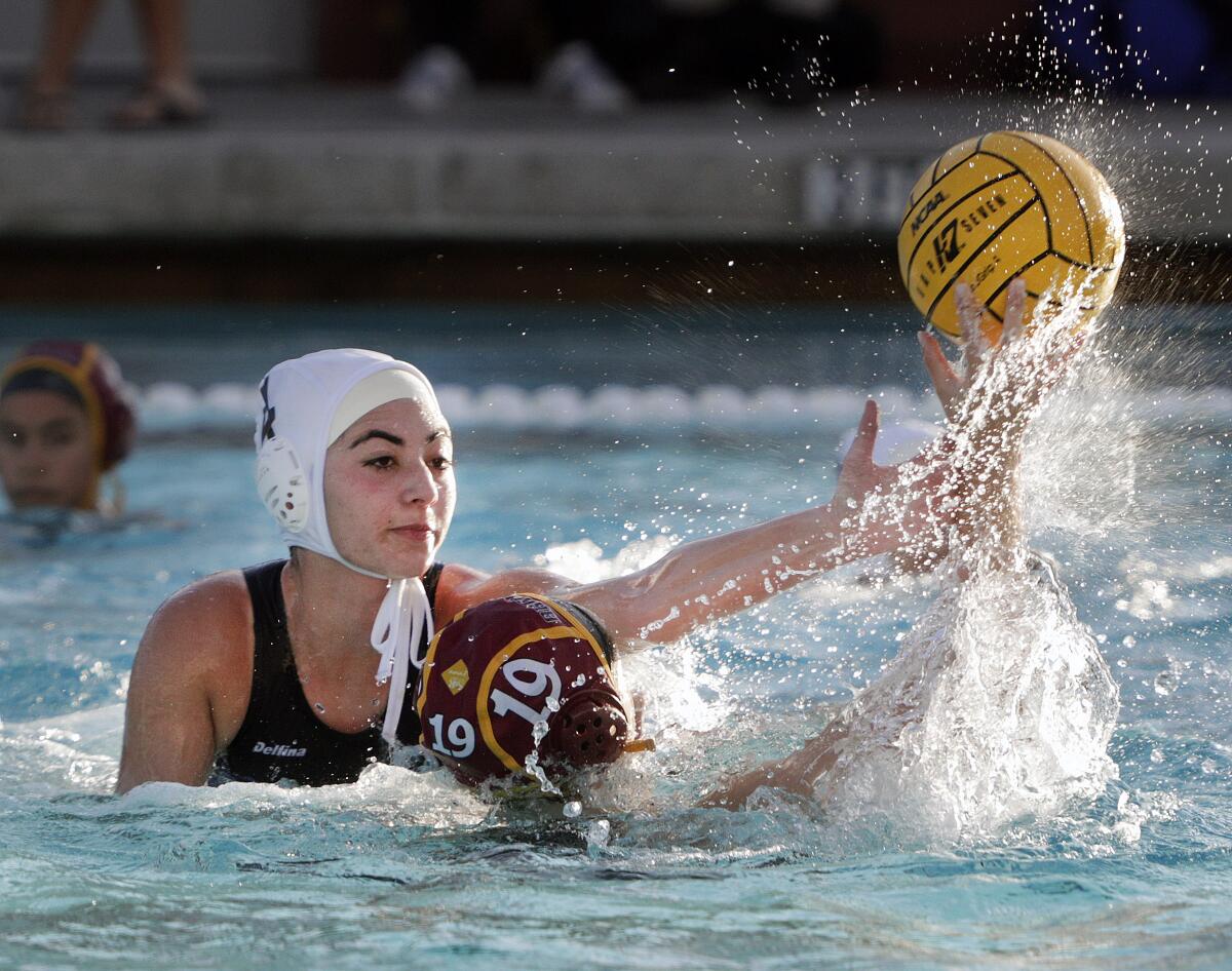 Burbank's Anasheh Abedian defends against the pass against Arcadia's Cassandra O'Connor in a Pacific League girls' water polo match at Arcadia High School on Thursday, January 9, 2020.
