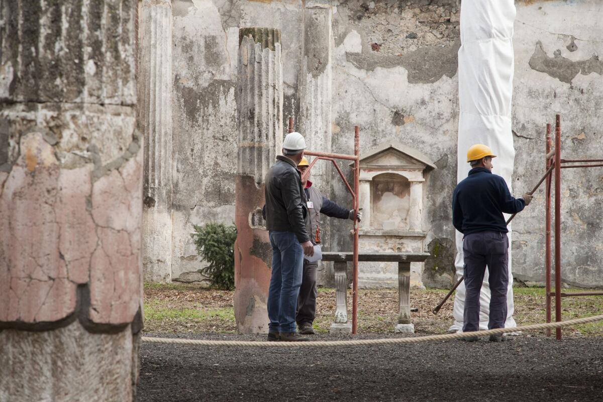 Restoration crews work on a building at the ancient Roman city of Pompeii.