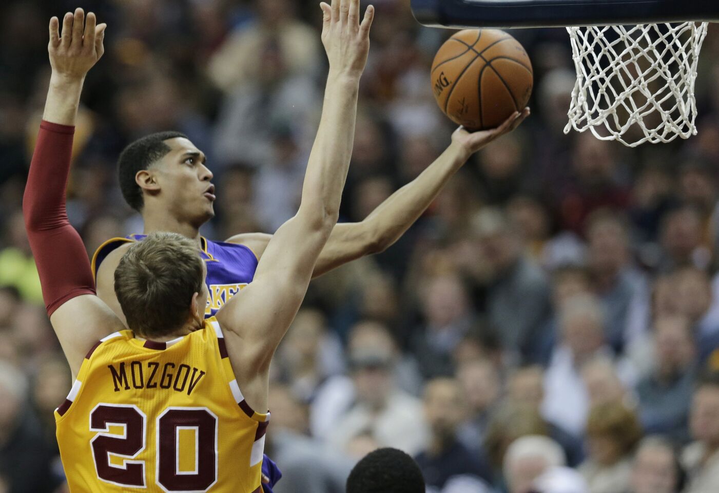 Lakers guard Jordan Clarkson drives to the basket in front of Cavaliers center Timofey Mozgov during the first half of a game on Feb. 10.