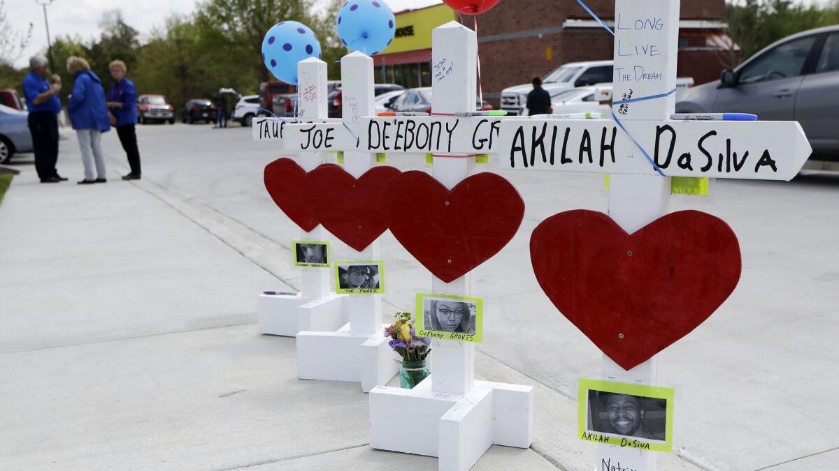 Four wooden crosses stand as a memorial for the four shooting fatalities outside a Waffle House restaurant in Nashville on Wednesday.