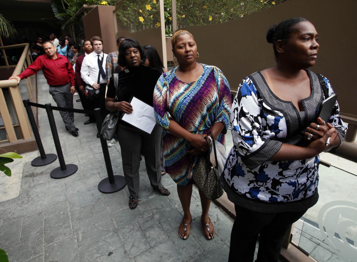 A Labor Department watchdog called for an end to the "lockup" method of releasing important jobs data to media first. Above, job applicants waiting for a job fair in Los Angeles.