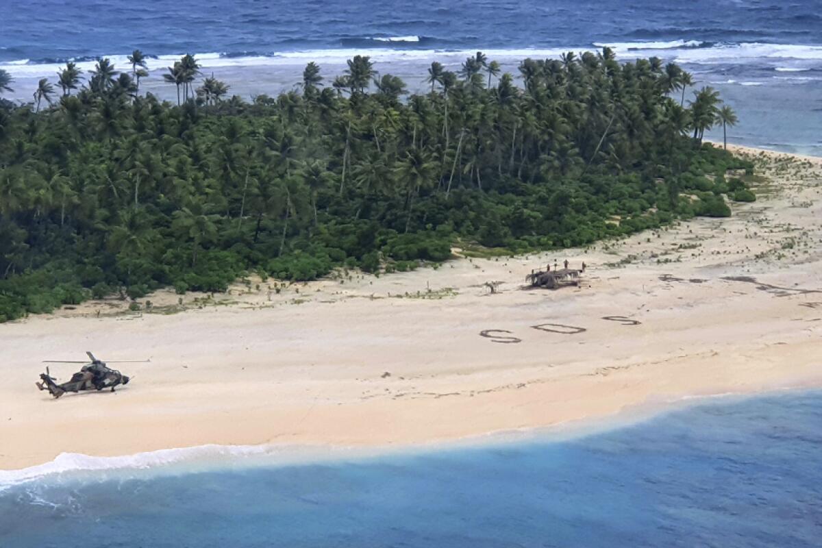 Three missing men were found after searchers spotted their SOS sign in the sand at Pikelot Island.