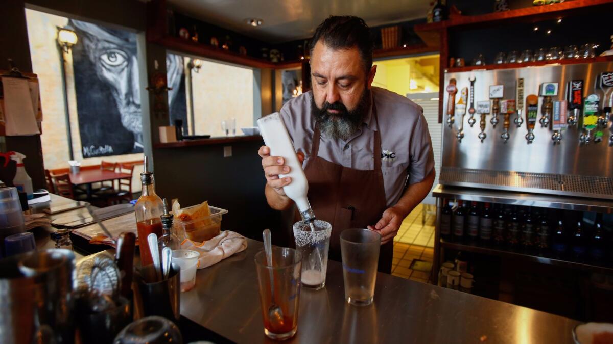 Ricardo Diaz prepares a michelada in his restaurant Colonia Publica.