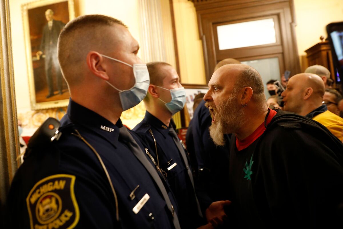 Protesters try to enter the Michigan House of Representatives chambers 