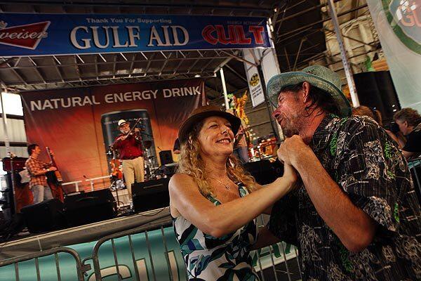The New Orleans group BeauSoleil plays during the Gulf Aid benefit concert, while Elizabeth Fredrickson and Bill Wheeler take a spin on the dance floor.
