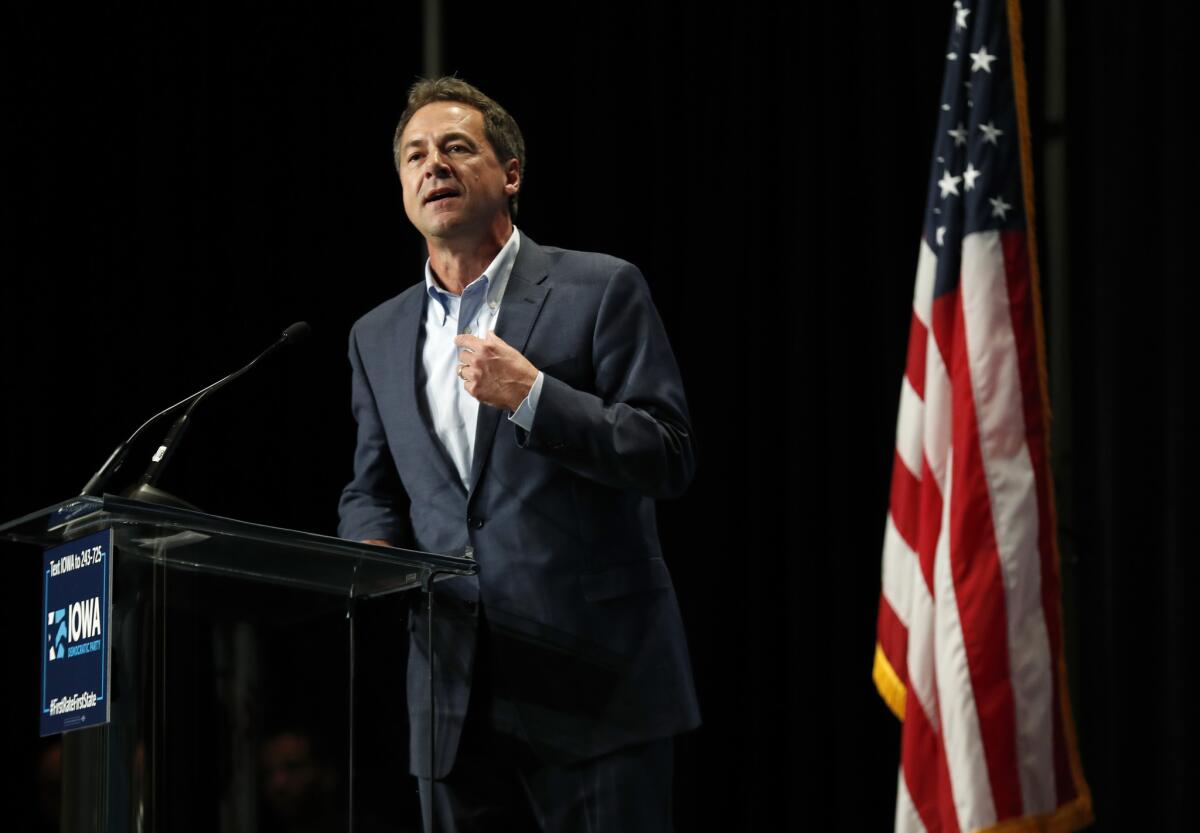 Montana Gov. Steve Bullock, shown in June in Cedar Rapids, Iowa, will join 19 other Democratic presidential candidates on a debate stage later this month.