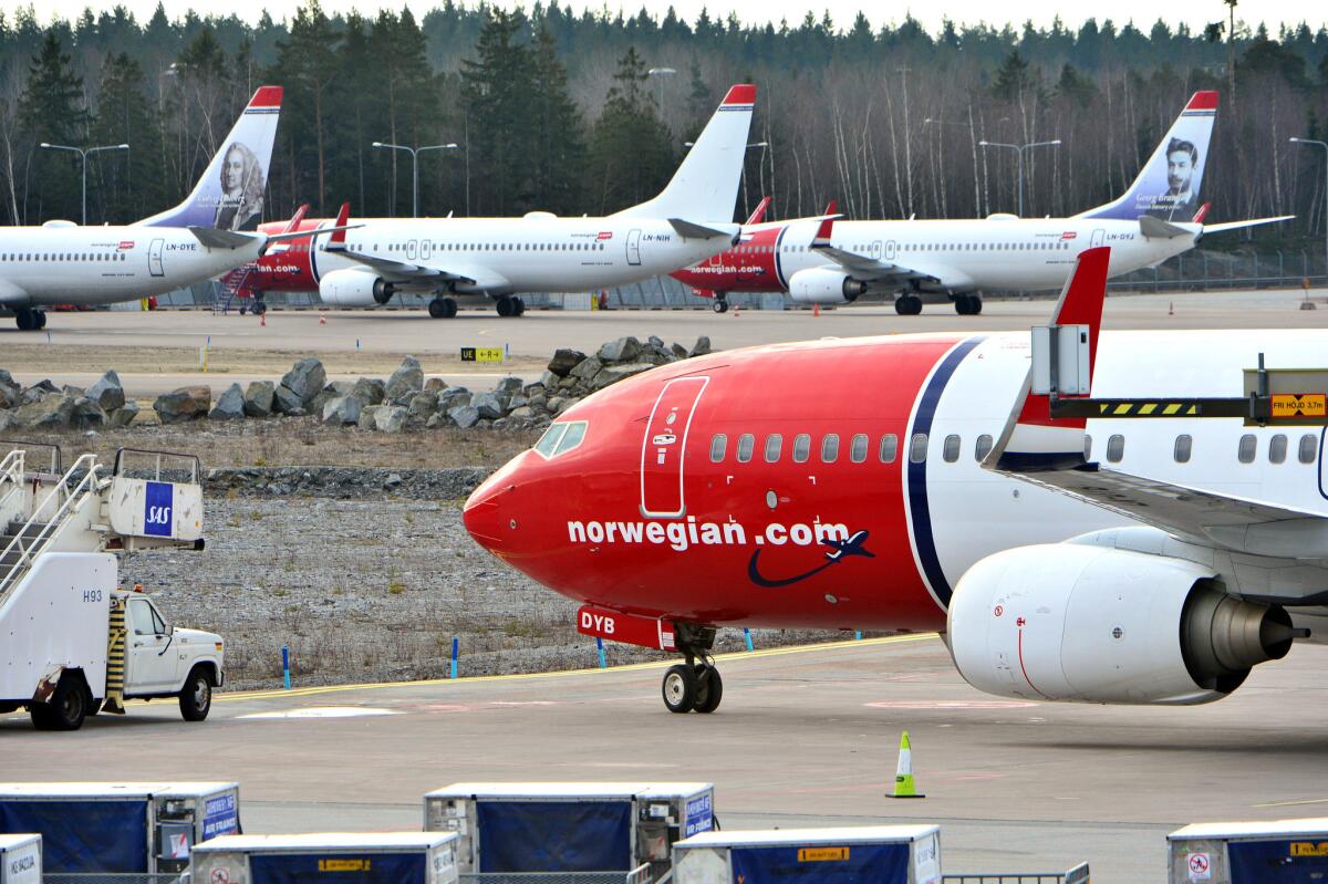 Aircraft for Norwegian Air Shuttle sit at the Stockholm Arlanda Airport. Delta Air Lines executives say they may consider offering no-frill seats to Europe to compete with a subsidiary of Norwegian Air Shuttle.