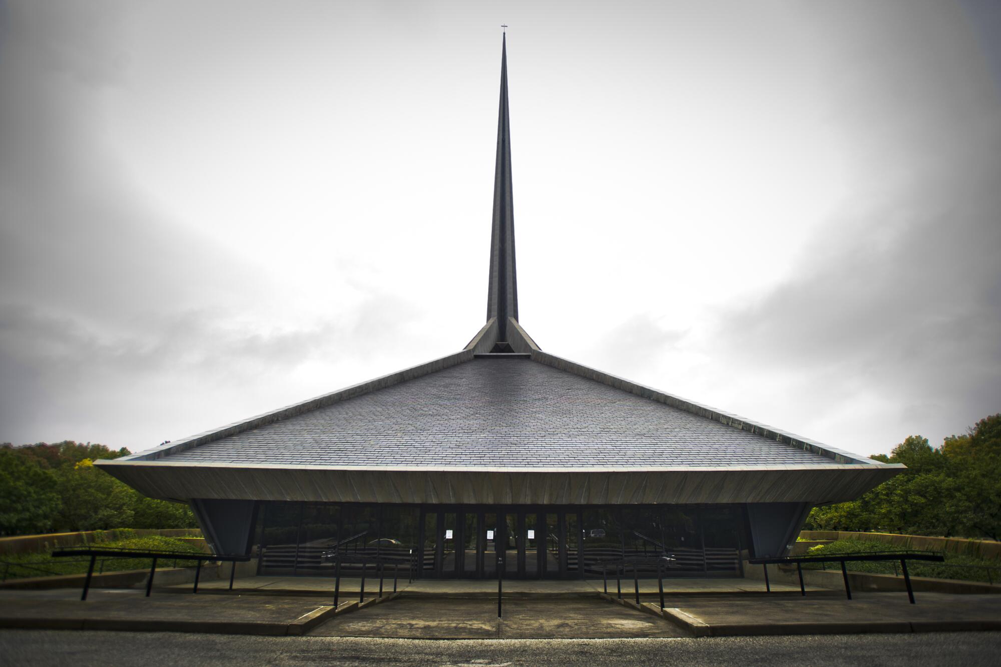 An exterior photo of the North Christian Church as its dramatic spire appears to part the clouds in Columbus, Ind.