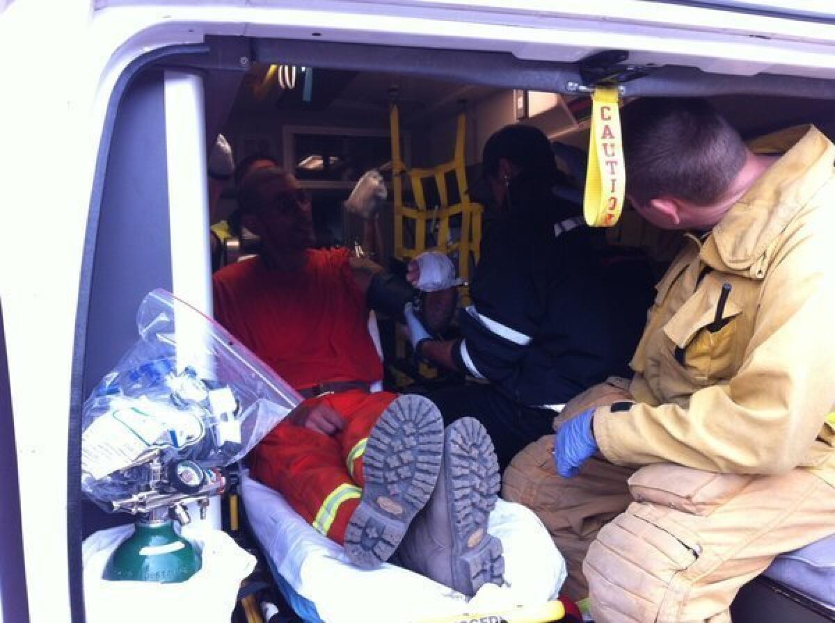 An injured member of a fire crew gets medical attention in the Hidden Valley area of Ventura County.