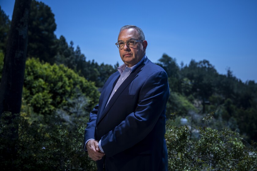 Fred Milstein, president of Media Guarantors, stands in the backyard of his Los Angeles home.