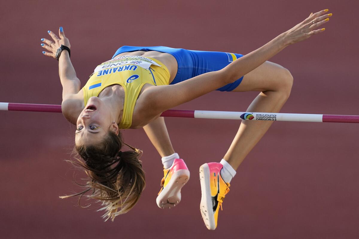 Yaroslava Mahuchikh wears yellow and blue in the women's high jump final.