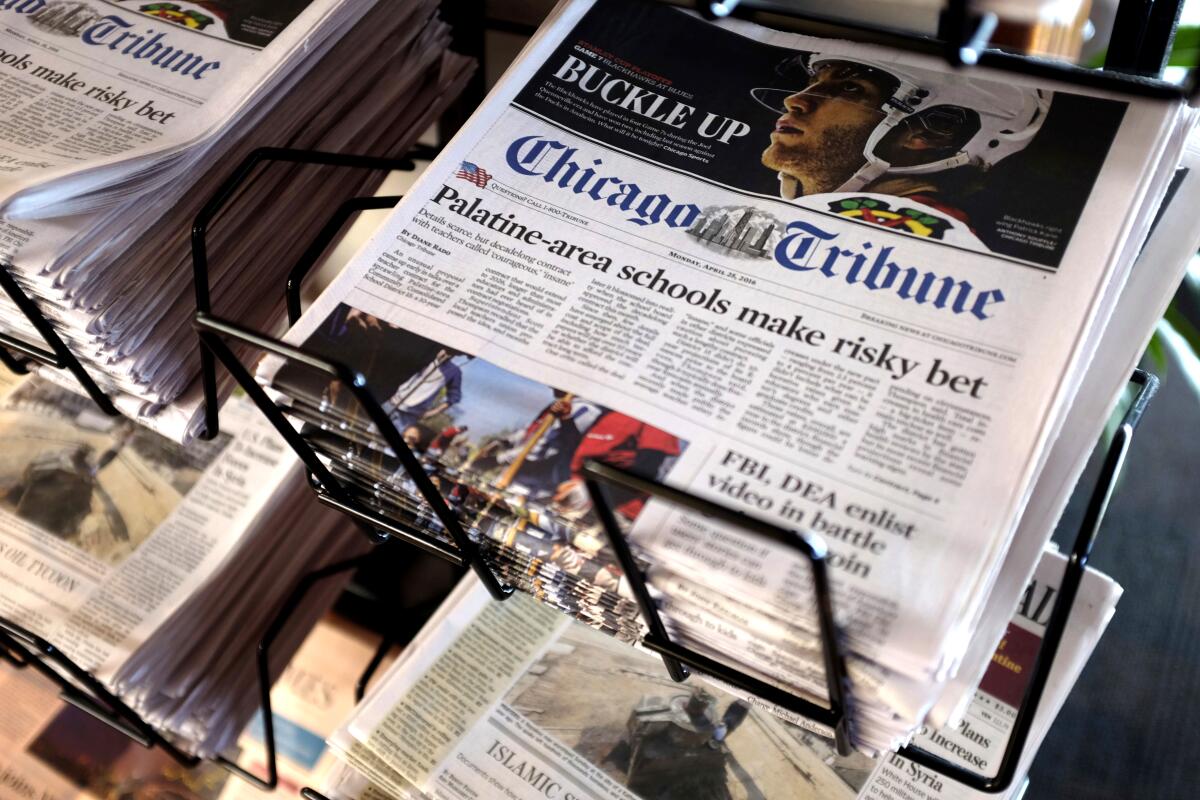 A stack of Chicago Tribune newspapers on a metal rack