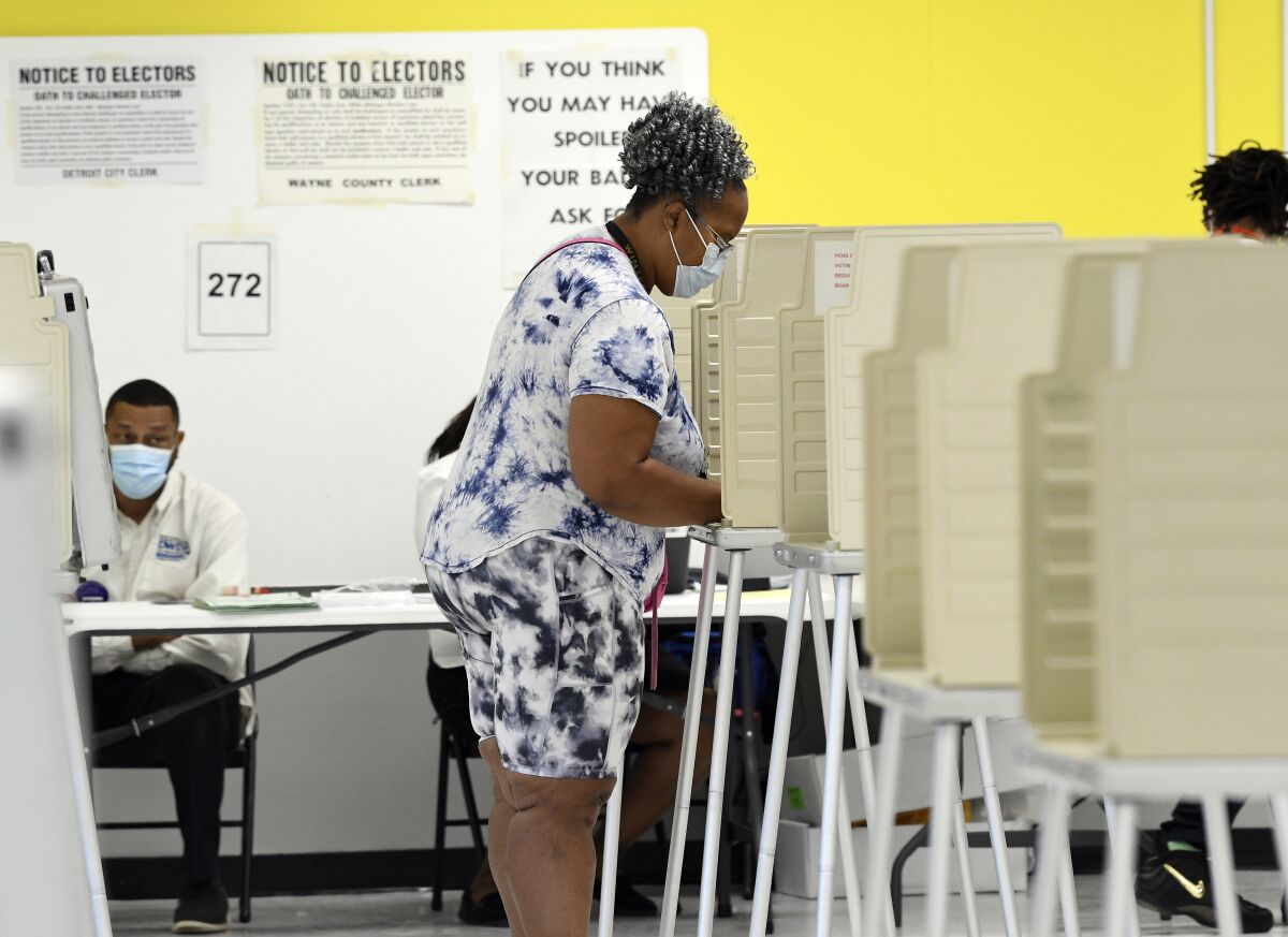 Jennifer Johnson, 61, of Detroit, votes at the Detroit Service Learning Academy in the state's primary election, Tuesday morning, Aug. 3, 2021, in Detroit. (Clarence Tabb Jr./Detroit News via AP)