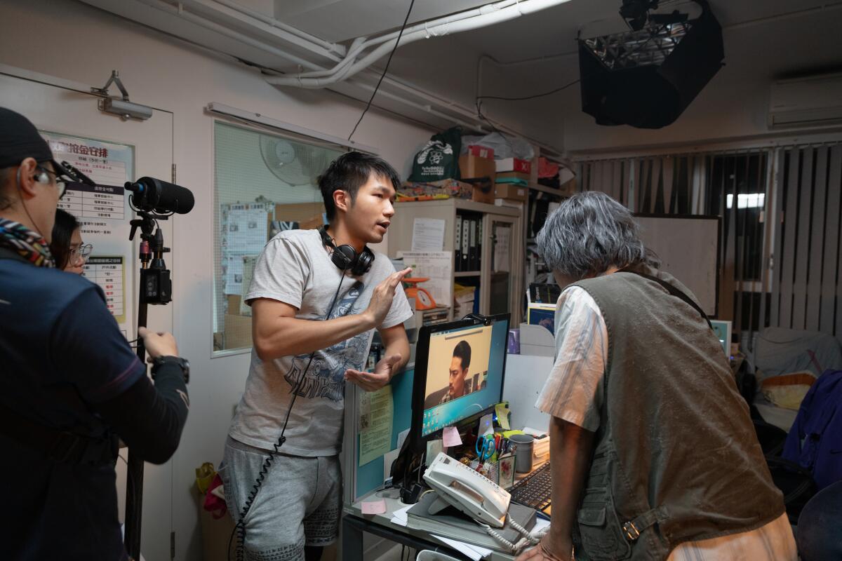 Hong Kong filmmaker Jun Li works with technicians on the set of his film "Drifting."