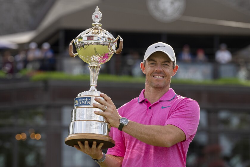 Rory McIlroy holds the trophy for his victory in the Canadian Open.