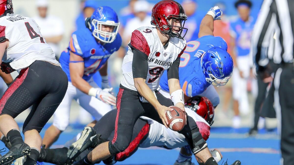 San Diego State quarterback Ryan Agnew, center, turns to toss the ball against Boise State during the second half on Saturday. San Diego State won 19-13.