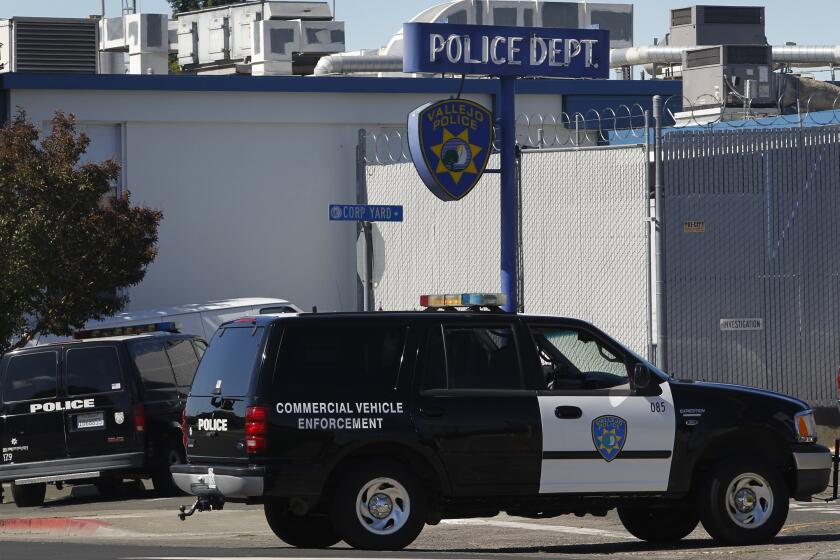 FILE - In this July 14, 2015, file photo, a police vehicle arrives at the department's headquarters in Vallejo, Calif. The police chief of a San Francisco Bay Area city under scrutiny after several fatal police shootings says he is opening an "official inquiry" into allegations that officers bent their badges to mark on-duty fatal shootings. Vallejo Police Chief Shawny Williams told the San Francisco Chronicle Wednesday, July 29, 2020, that badge bending would amount to misconduct and that a fact-finding mission may lead to an independent investigation. (Paul Chinn/San Francisco Chronicle via AP, File)