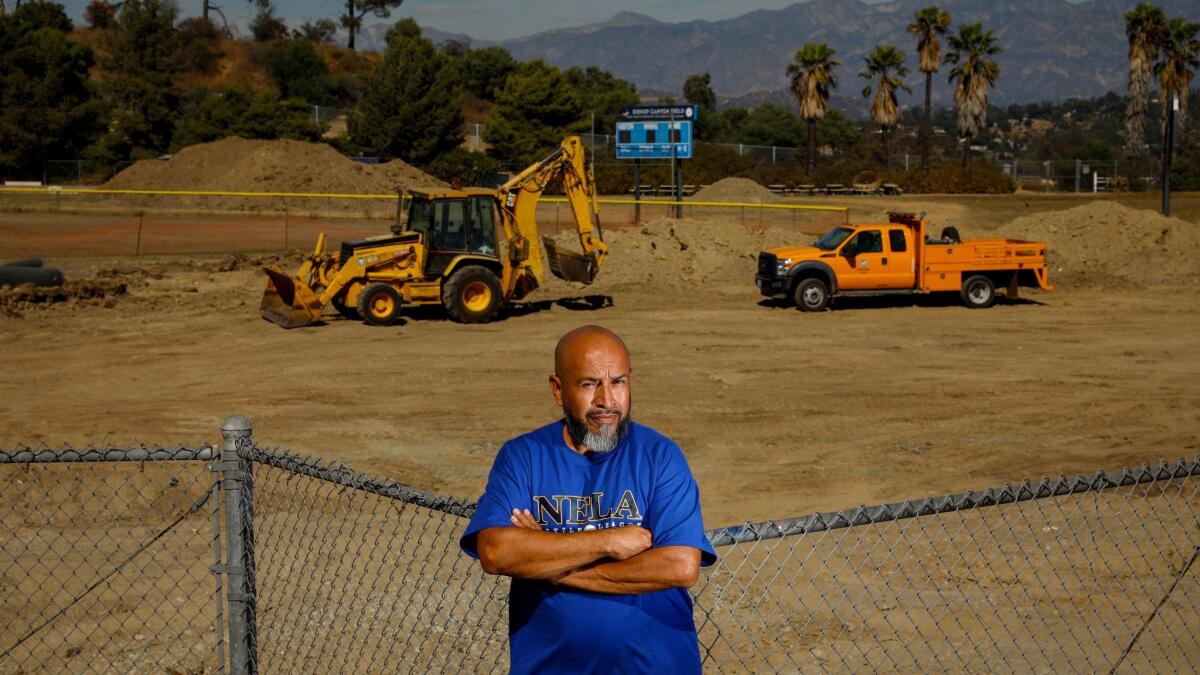 Sergio Villaseñor, president of the North East Los Angeles Little League, at the Bishop Canyon baseball fields at Elysian Park. They've have been closed for more than a year, after the removal of the leaning snack bar, caused by sinking soil.