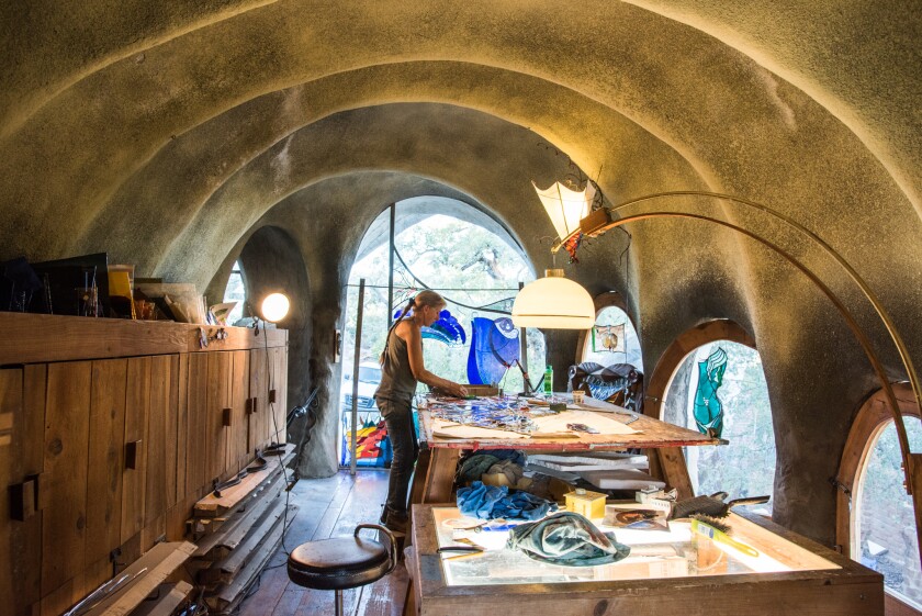 Stained glass artist Cindy Mushet-Shriver works on the firebird window at Hubbell Studios.