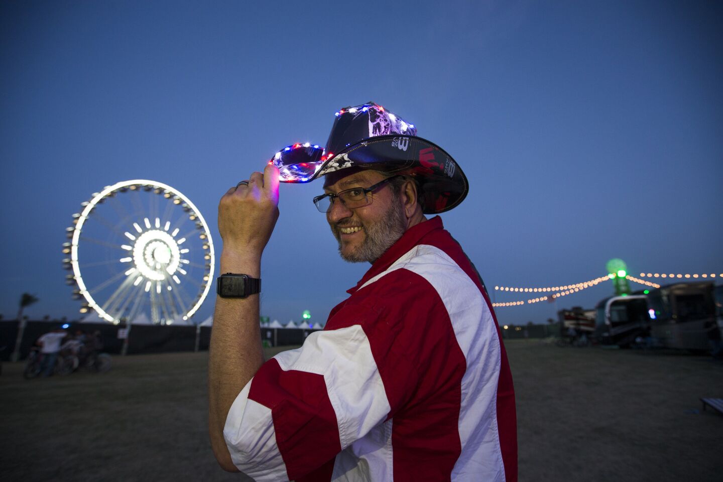 Country music fan Vito Pace, of Calabasas, sports LED lights on his hat at dusk in the RV Resort for the 10th anniversary of the Stagecoach Country Music Festival.