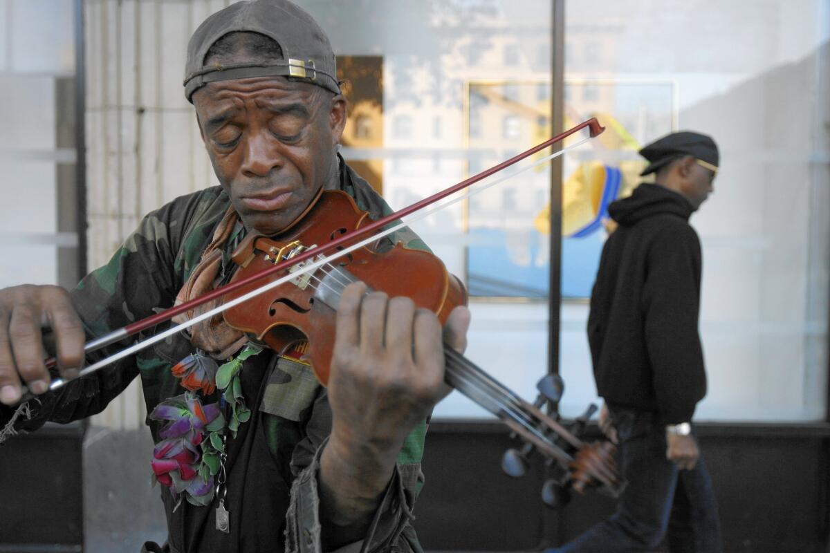 Nathaniel Ayers plays the violin in downtown Los Angeles in 2008.