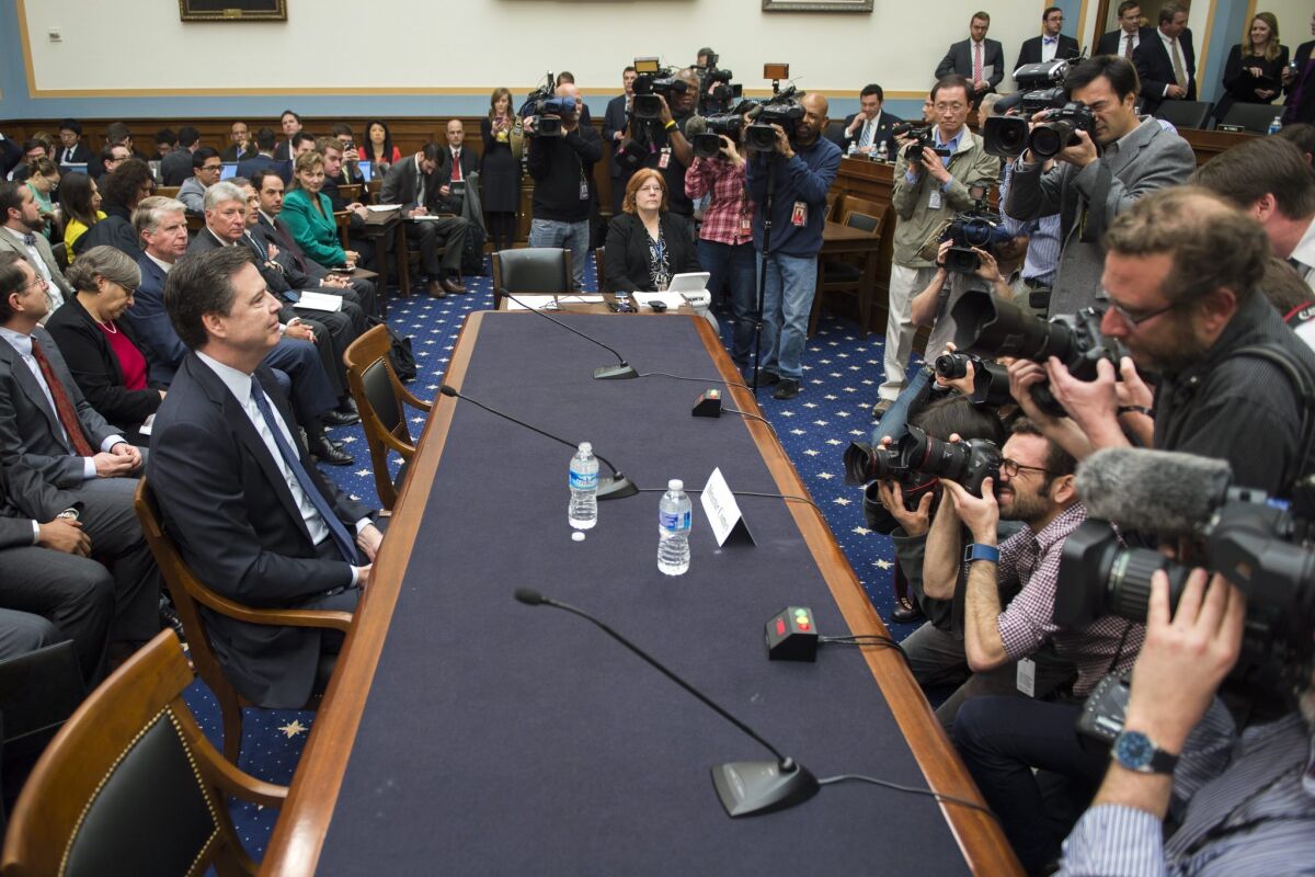 FBI Director James Comey, left, prepares to testify before Congress on Tuesday about the issues in his encryption fight with Apple.