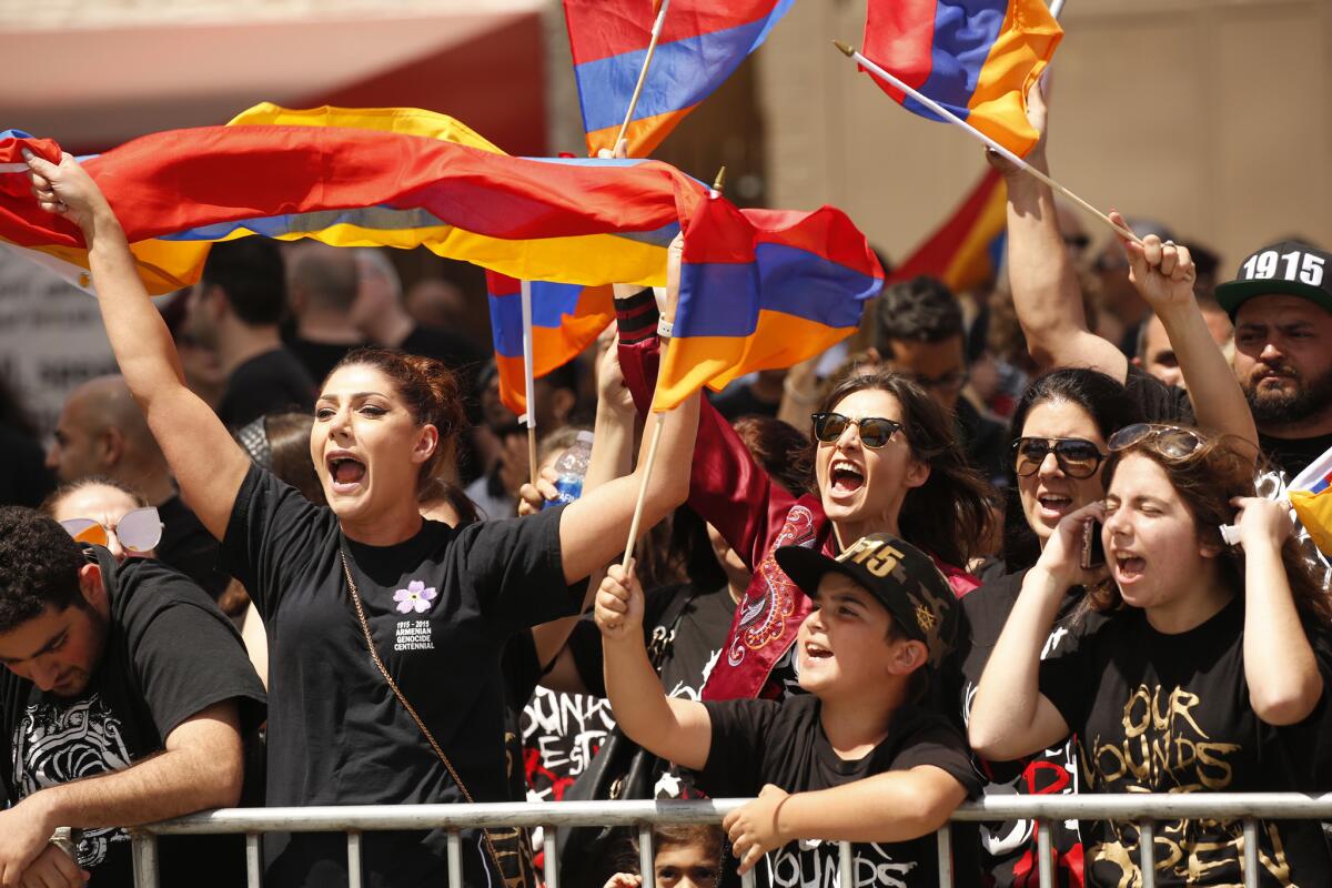 Crowds gather at the Turkish consulate in Los Angeles to mark the 102nd anniversary of the Armenian genocide.