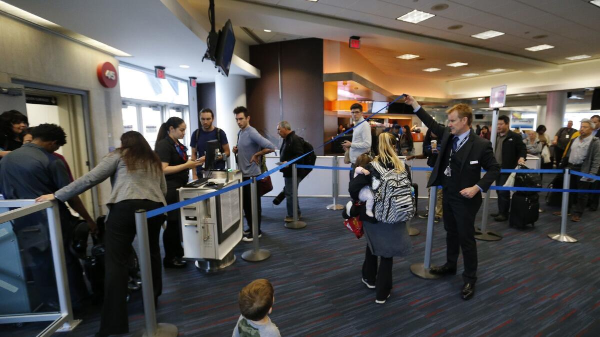 Passengers line up to board American Airlines 2381 flight to Orlando at Los Angeles International Airport. American Airlines will begin in December to allow fliers with nut allergies to board early.