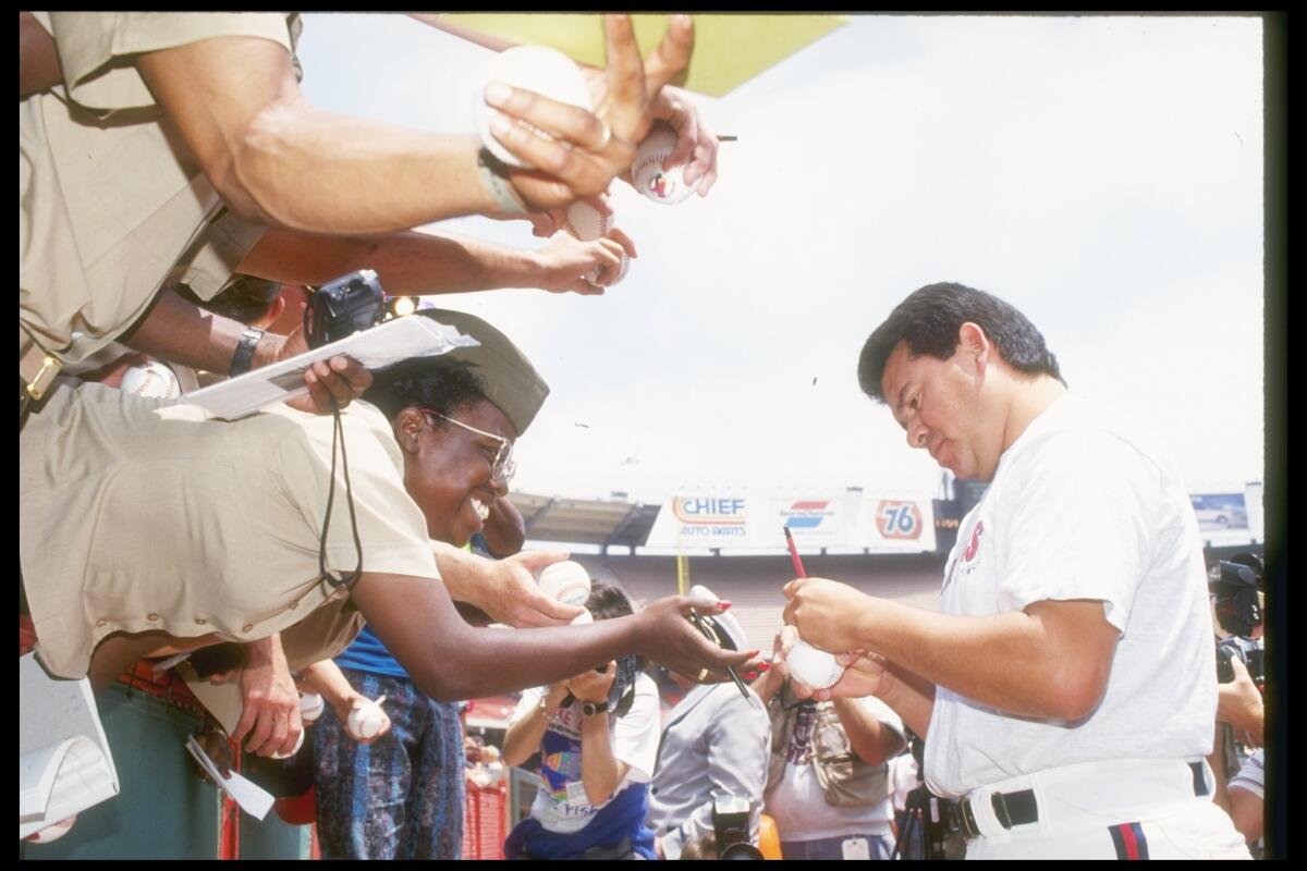 Fernando Valenzuela signs autographs before an Angels home game in 1991.