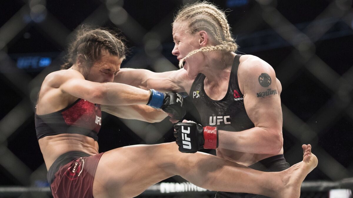 Valentina Shevchenko, right, fights Joanna Jedrzejczyk during the women's flyweight championship bout at UFC 231 in Toronto.