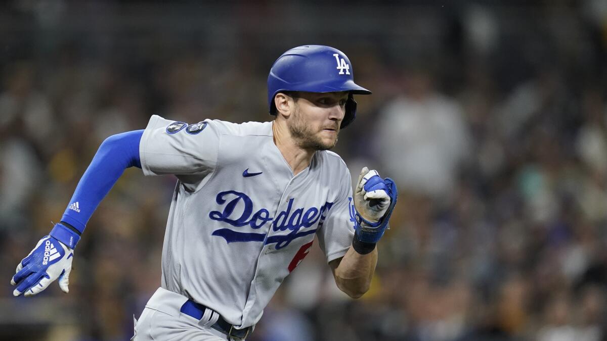 Dodgers' Trea Turner hits a bunt single during the seventh inning in Game 4 against the Padres.