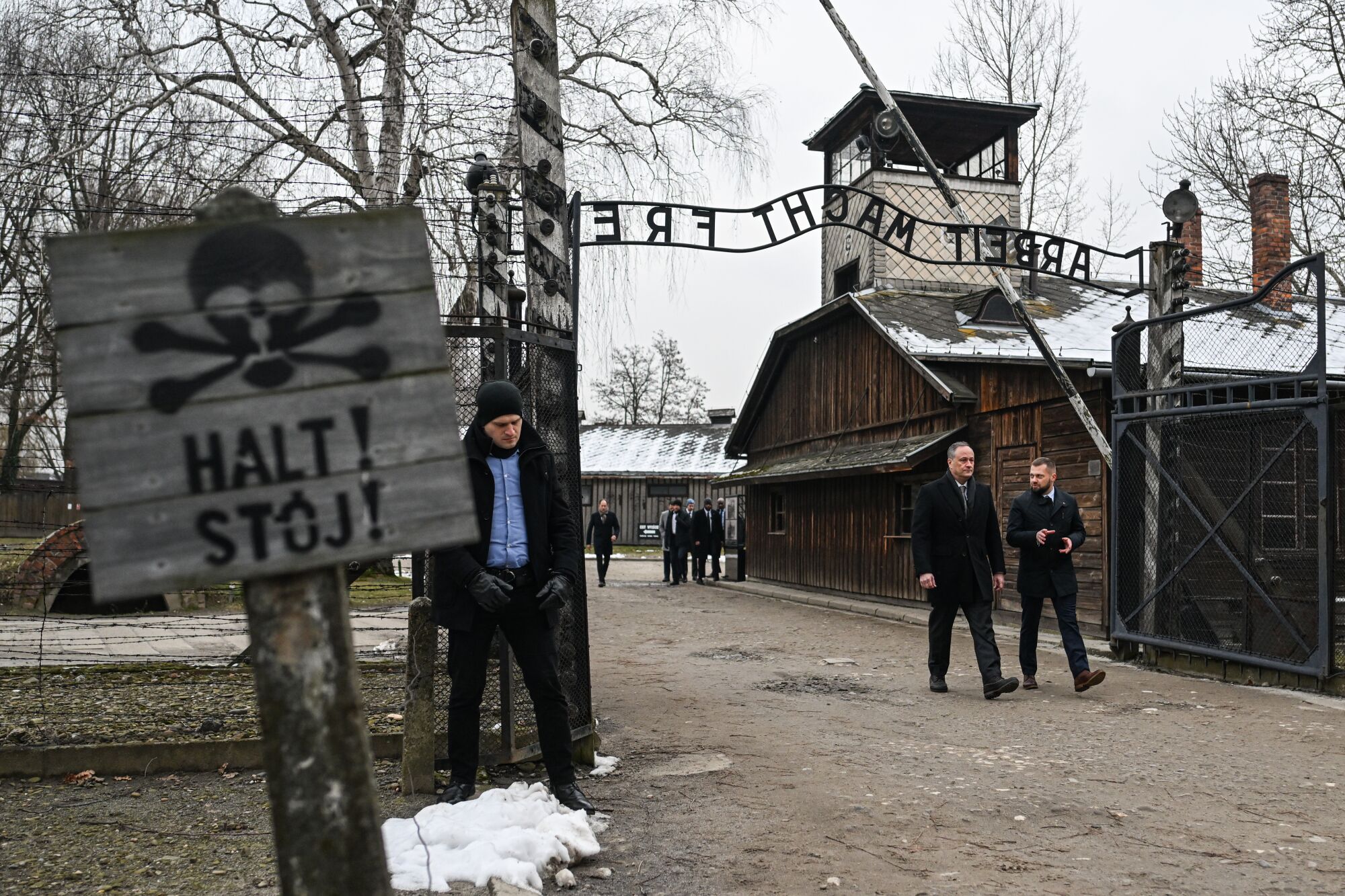 Douglas Emhoff walks past the main gate of the former Auschwitz Concentration Camp