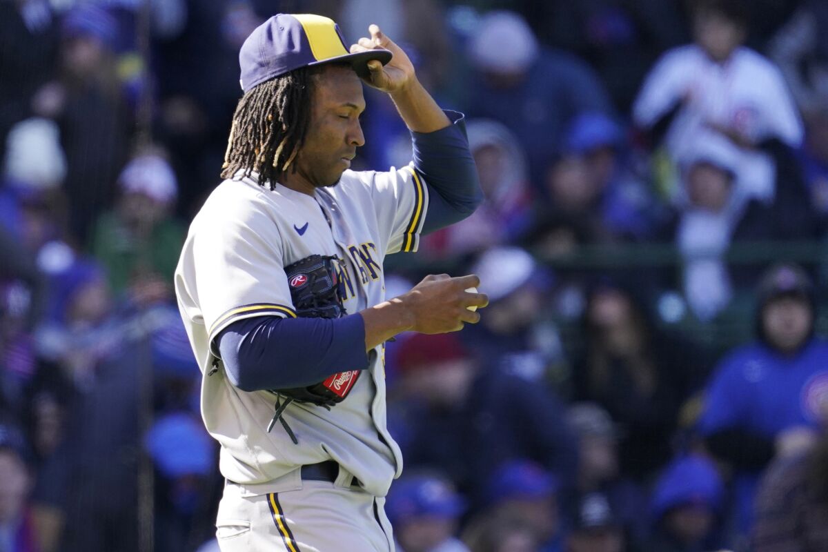 Milwaukee Brewers relief pitcher Jose Urena reacts after Chicago Cubs' Ian Happ scored by his wild pitch during the fourth inning of a baseball game in Chicago, Saturday, April 9, 2022. (AP Photo/Nam Y. Huh)