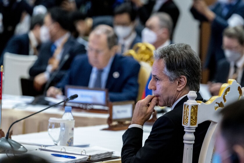 Secretary of State J. Antony Blinken sits at a table near Russian Foreign Minister Sergei Lavrov.