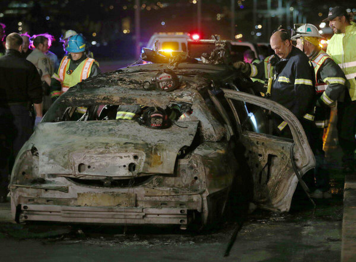 San Mateo County firefighters and California Highway Patrol personnel investigate the scene of a limousine fire on the San Mateo-Hayward Bridge.