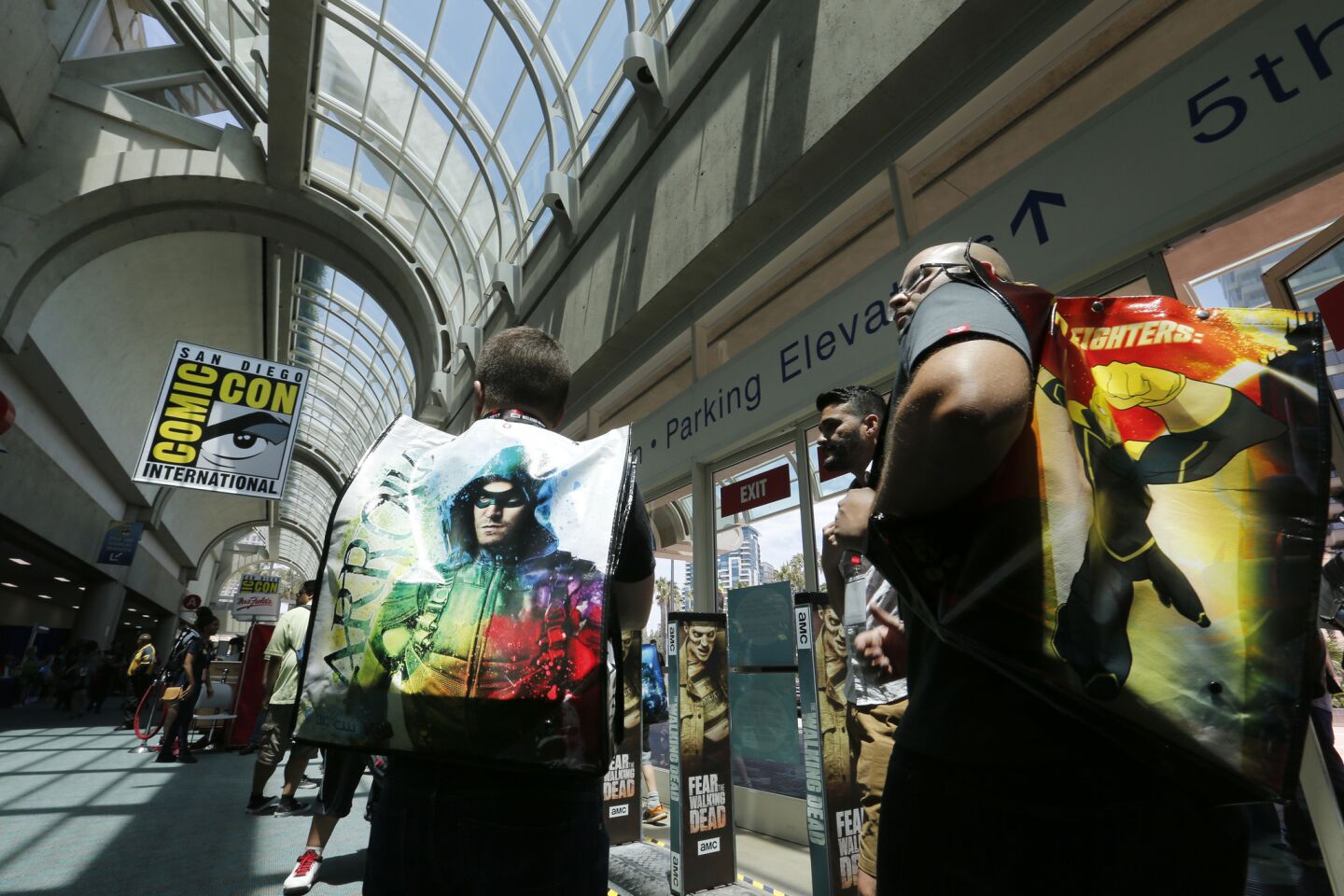 Mauricio Leal, left, and Rodolfo Resendez, both of Monterrey, Mexico, pick up their entry badges and bags to Comic-Con International 2017 at the San Diego Convention Center.