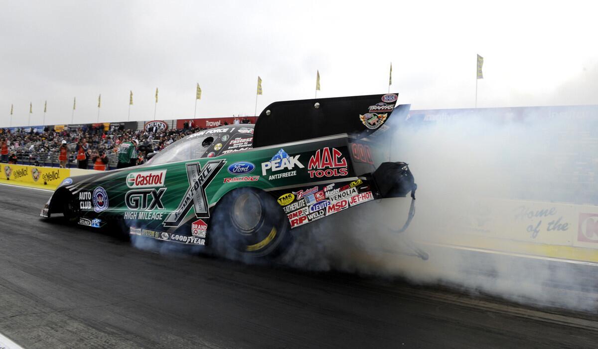 Veteran Funny Car driver John Force powers his Castrol GTX High Mileage Ford Mustang to his 16th overall event victory at Auto Club Raceway at Pomona on Feb. 9, 2014.