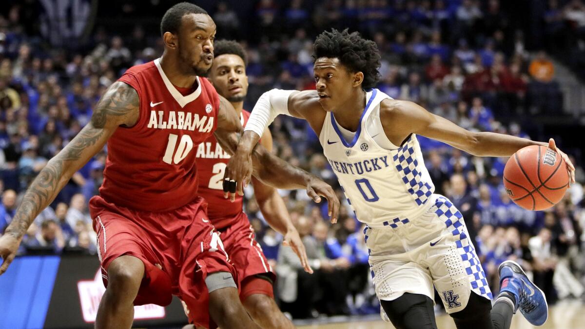 Kentucky guard De'Aaron Fox drives down the lane against Alabama forward Jimmie Taylor during the first half Saturday.