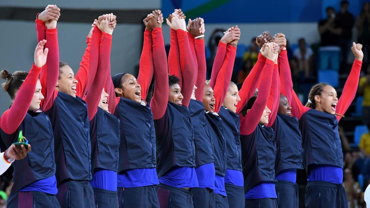 USA's women's basketball team celebratesl after defeating Spain for the gold medal.