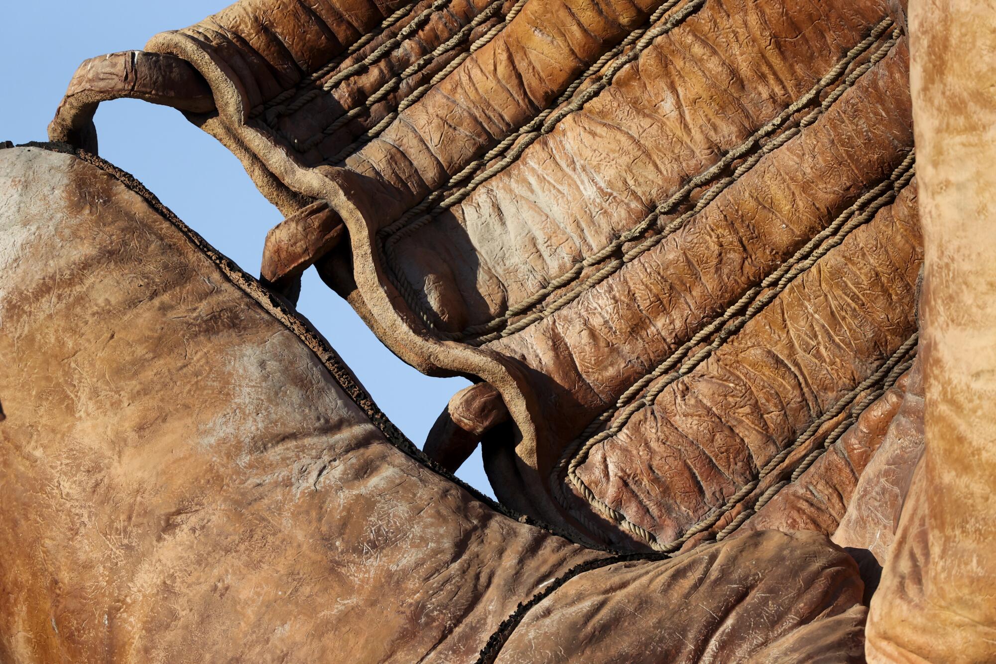  A detailed view of a statue of a glove in the outfield of Oracle Park.