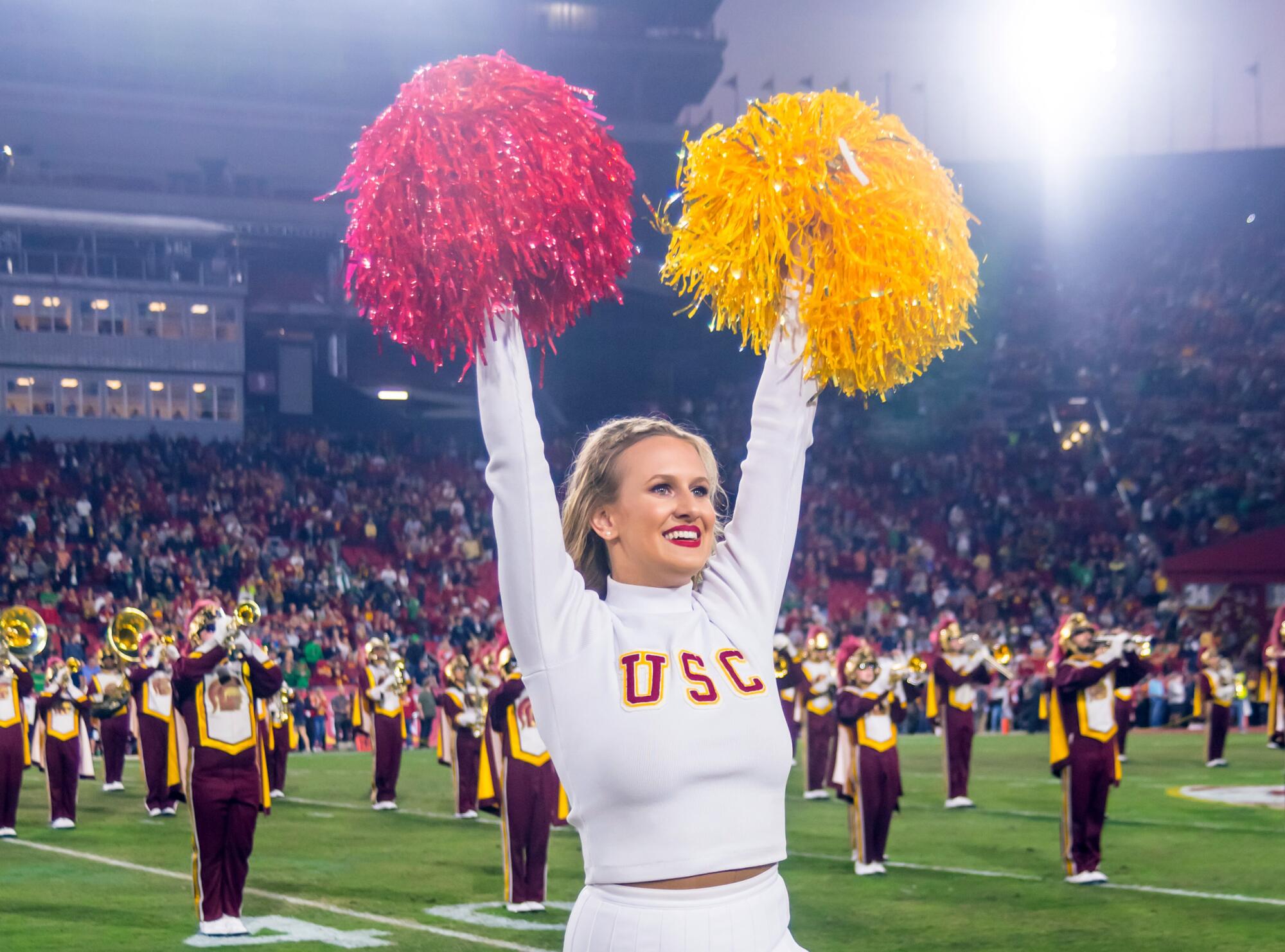 USC Song Girl Josie Bullen on the sideline as band plays on the field
