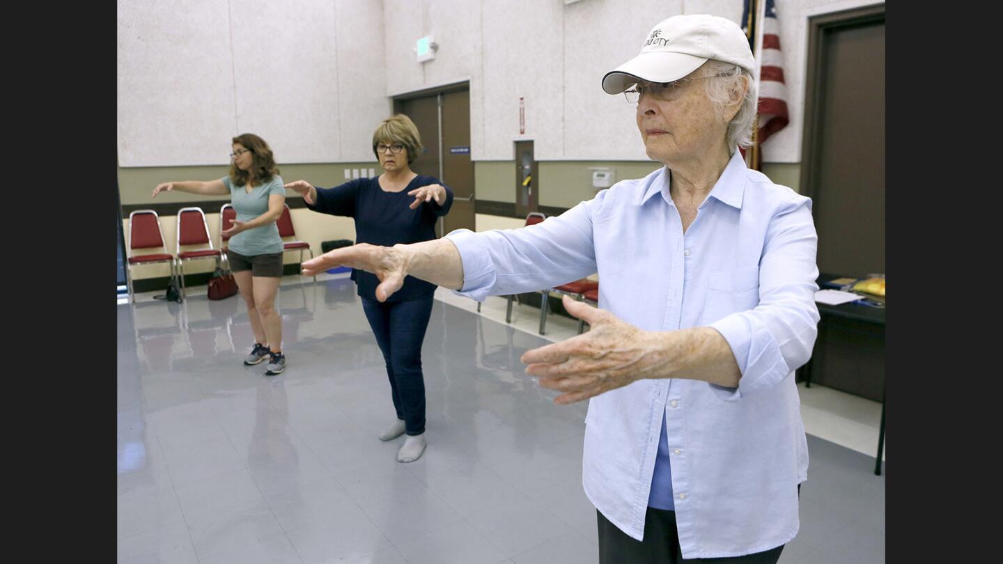 Left to right, Lee Denis, Deanna Cendejas and Mary Ostraff follow directions from Tai Chi instructor Roy Lopez during class at the Joslyn Adult Center in Burbank on Friday, July 7, 2017.