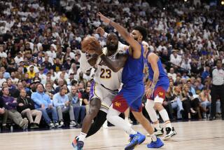 Lakers forward LeBron James drives to the basket against Nuggets guard Jamal Murray during their playoff game Saturday