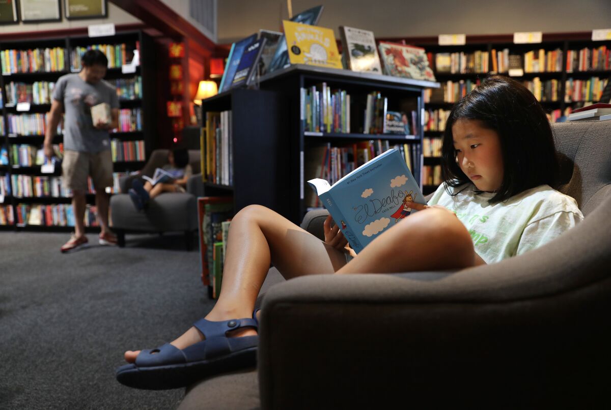 Noelle Park, 8, reads at Chevalier's Books.