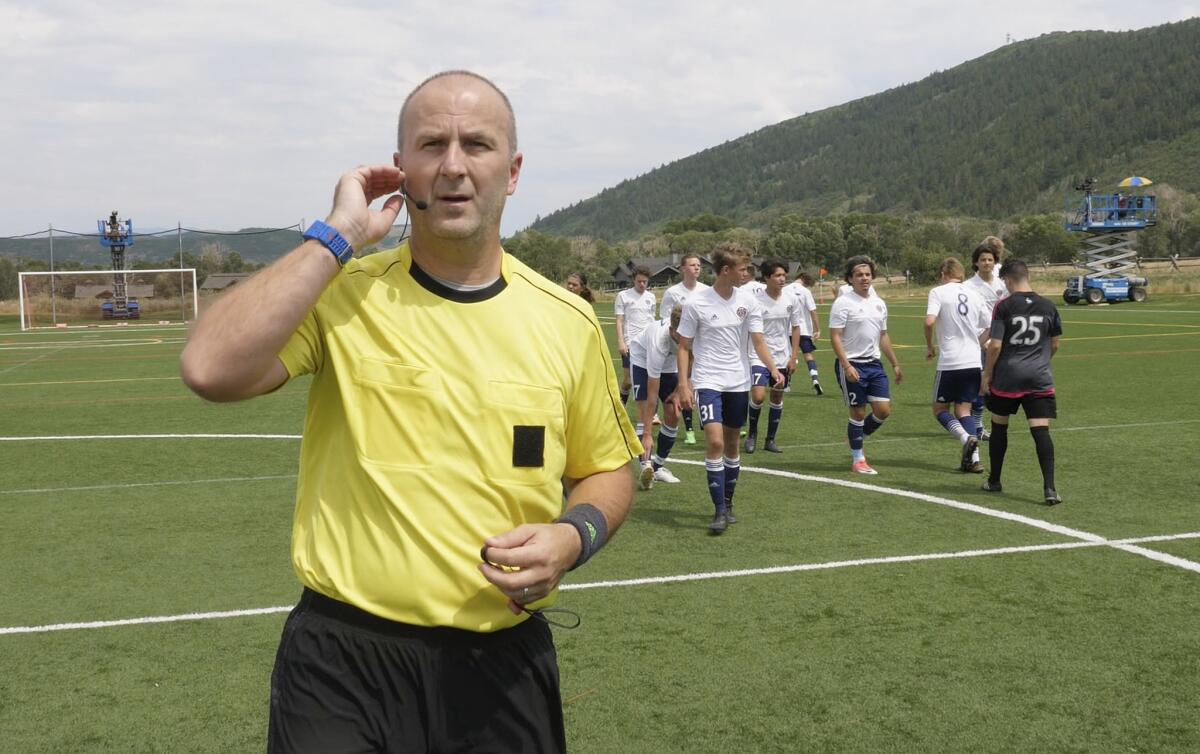 MLS referee Silviu Petrescu tests a headset used to communicate with a video assistant referee during a scrimmage staged as part of the final MLS training camp for referees in July.