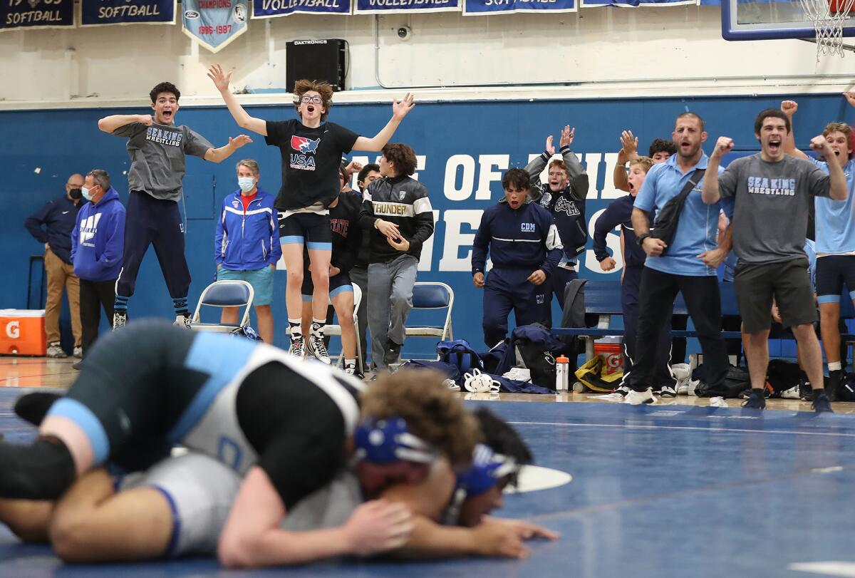 The Corona del Mar bench erupts in cheer as CdM's Anthony Leon turns Western's Alejandro Hernandez during the CIF Duals.